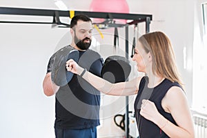 young woman boxing with personal trainer