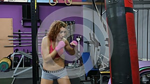 Young woman boxing on a punching bag