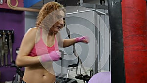 Young woman boxing on a punching bag