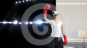 Young woman boxing in VR glasses . Mixed media