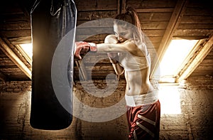 Young woman boxing workout on the attic photo