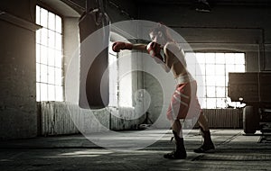 Young woman boxing workout in an old building