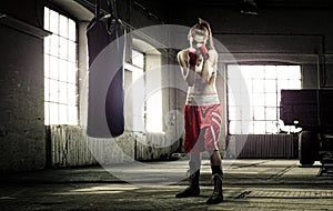 Young woman boxing workout in an old building