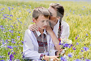 Young woman & boy on summer wheat fields