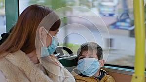 young woman with boy wearing medical mask will take precautions to protect against coronavirus infection travel in