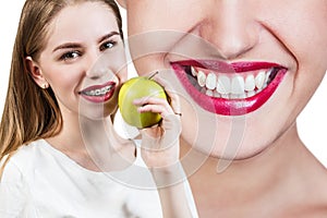 Young woman with brackets on teeth eating apple