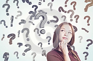 Young woman with braided hair and floating question marks in sun