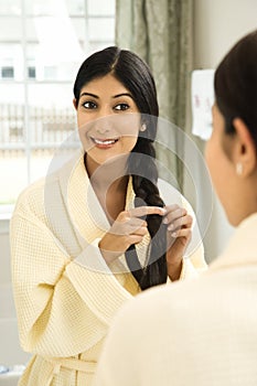 Young Woman Braiding Her Hair