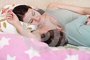 Young woman breastfeeding her baby at home. Milk from mother& x27;s breast is a natural medicine to baby. Mother day