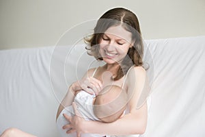Young woman breastfeeding photo