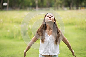 Young woman breathe fresh air in spring park