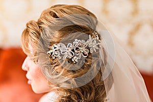 Young woman bride with beautiful hairstyle and stylish hair accessory, rear view