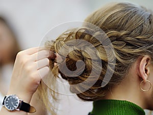 Young woman bride getting her hair done before wedding or party