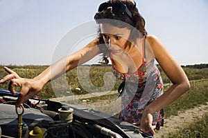 Young woman and a broken car