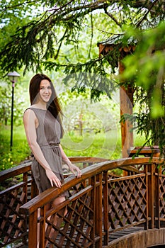 Young woman the brunette in the spring blossoming garden