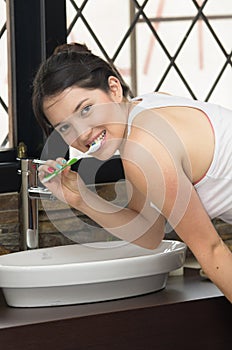 Young woman brushing teeth