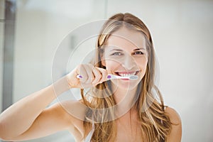 Young woman brushing teeth