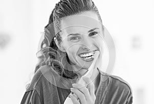 Young woman brushing teeth in bathroom