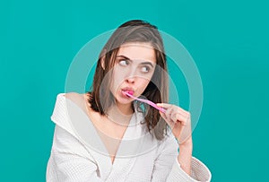 Young woman brushing teeth. Happy funny girl brush her teeth on isolated background. Beautiful wide smile of young woman