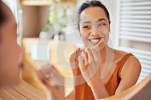 Young woman brushing teeth at home with toothbrush