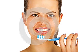 Young woman brushing teeth over white backgrund.