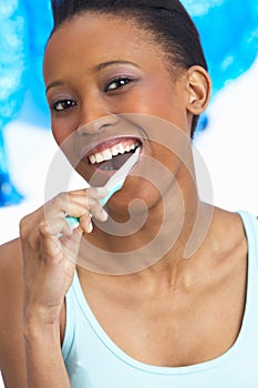 Young Woman Brushing Teeth In Studio