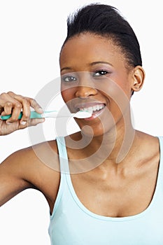 Young Woman Brushing Teeth In Studio