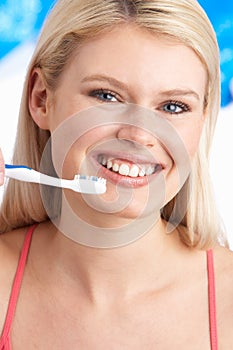 Young Woman Brushing Teeth In Studio