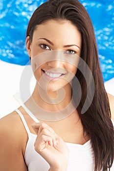 Young Woman Brushing Teeth In Studio