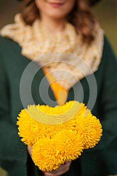 Young woman with bunch of wildflowers