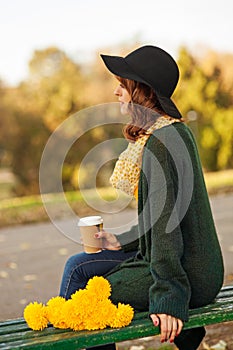 Young woman with bunch of yellow flowers