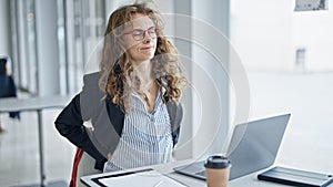 Young woman business worker suffering for backache working at the office