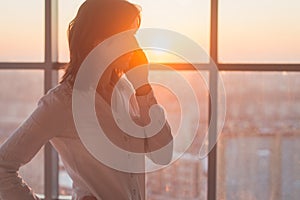 Young woman busy with calling, chatting on the cell phone side view portrait. Close-up picture of a businesswoman