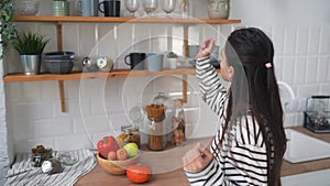 Young woman busy in modern kitchen, attractive girl preparing food