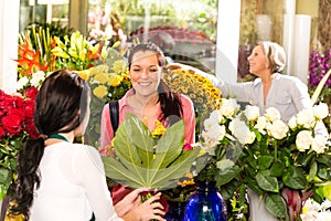 Young woman buying bouquet flower shop customer