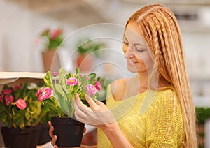 Young woman buying flowers at a garden center