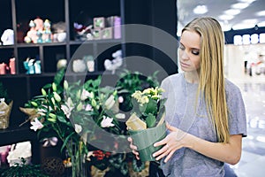 Young woman buying flowers at a garden center