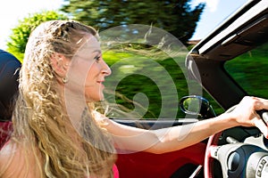 Young woman with cabriolet in summer on day trip