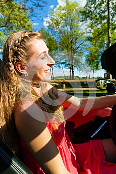 Young woman with cabriolet in summer on day trip