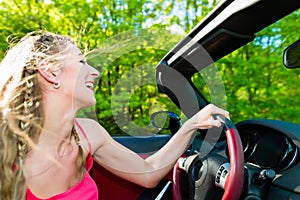 Young woman with cabriolet in summer on day trip