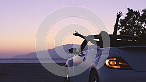 Young Woman in Cabriolet at Sunset