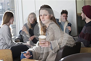 Young woman at a cafe with her friends