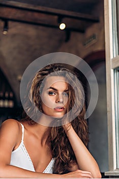 Young woman in a cafe looking out of window