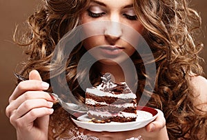 Young woman with a cake close up