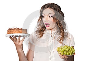 Young woman with cake and grapes isolated