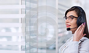 Young woman call center operator in headset on business office b