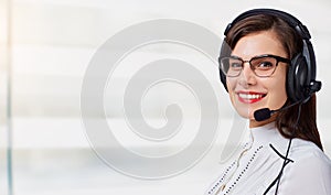 Young woman call center operator in headset on office background