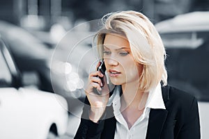 Young fashion business woman calling on cell phone