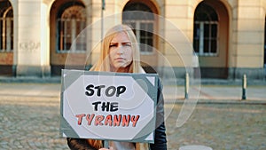 Young woman calling to stop the tyranny by holding steamer photo
