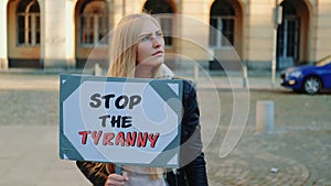 Young woman calling to stop the tyranny by holding steamer